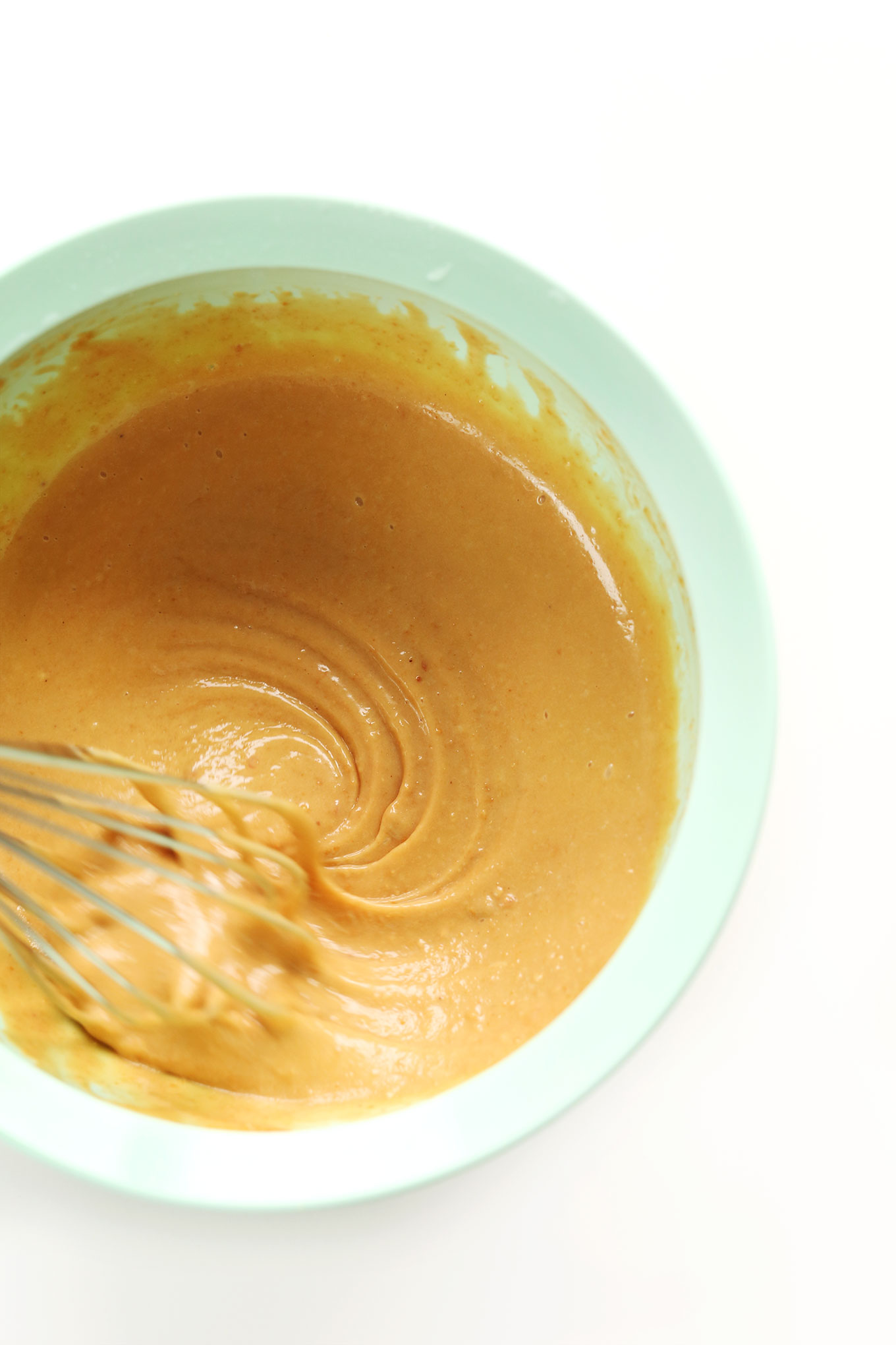 Whisking a bowl of simple homemade peanut sauce